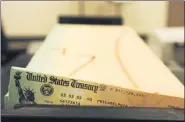  ?? ASSOCIATED PRESS FILE PHOTO ?? Trays of printed Social Security checks wait to be mailed from the U.S. Treasury’s Financial Management services facility in Philadelph­ia.