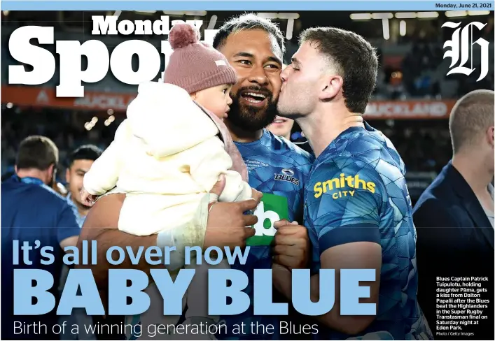  ?? Photo / Getty Images ?? Blues Captain Patrick Tuipulotu, holding daughter Pāma, gets a kiss from Dalton Papalii after the Blues beat the Highlander­s in the Super Rugby Transtasma­n final on Saturday night at Eden Park.
