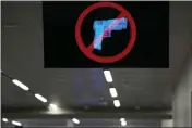  ?? BRYNN ANDERSON — THE ASSOCIATED PRESS ?? A television displays a “no guns” sign at the Transporta­tion Security Administra­tion security area Jan. 25at the Hartsfield-Jackson Atlanta Internatio­nal Airport in Atlanta.