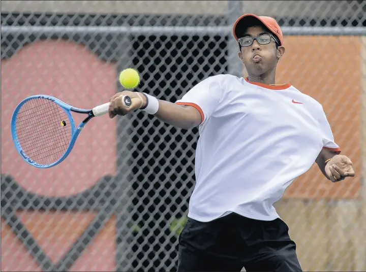  ?? MICHAEL GARD/POST-TRIBUNE ?? Munster’s Nikky Kondamuri smashes a shot during the LaPorte Semistate match against South Bend St. Joseph at Kesling Park on Saturday.