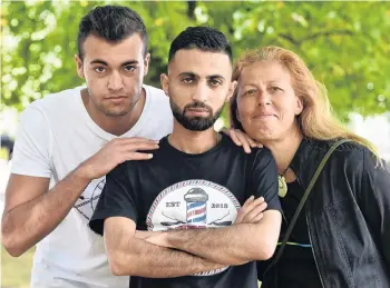  ?? PHOTO: PETER MCINTOSH ?? Supporters . . . Syrian former refugee Mohammad Saad Aldeen (centre) with his friends Naser Tamimi (left) and Jane Macdonald on Wednesday.