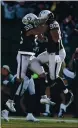  ?? ARIC CRABB — BAY AREA NEWS GROUP, FILE ?? The Raiders’ Marquel
Lee and Kony Ealy (96) celebrate after a play during their game against the Steelers in December 2018. The Raiders are set to play the Steelers again in 2021.