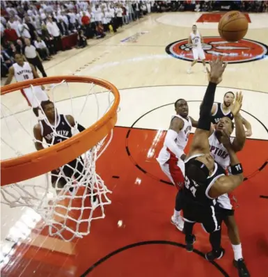  ?? RICK MADONIK/TORONTO STAR ?? Brooklyn’s Paul Pierce, lower right, blocks a potential winning runner by the Raptors’ Kyle Lowry to seal the Nets’ Game 7 win.