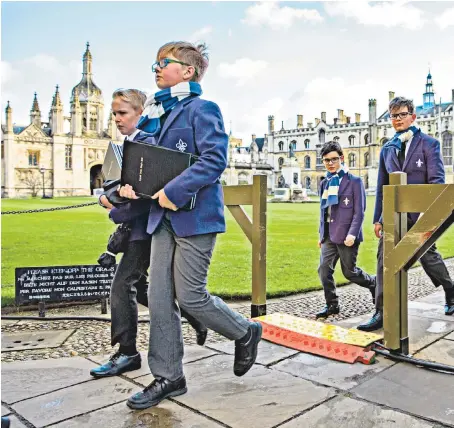  ??  ?? Choristers from King’s College Cambridge arrive for the final rehearsal in the King’s Chapel yesterday for the Festival of Nine Lessons and Carols, which will be broadcast live on BBC Radio 4 at 3pm on Christmas Eve. The Festival was introduced in 1918 to bring a more imaginativ­e approach to worship, and was first broadcast in 1928.