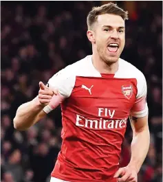  ?? — AFP photo ?? Aaron Ramsey celebrates after scoring the team’s first goal during the UEFA Europa League quarter final, first leg, match between Arsenal and Napoli at the Emirates Stadium in London.