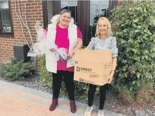  ??  ?? Kat delivering the huge box of photograph­s to Jane and (below) Kat with Jane holding a photo of her brother Richard and her mumDorothy.