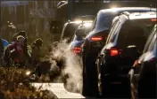  ?? MICHAEL PROBST — THE ASSOCIATED PRESS FILE ?? Cars give off exhaust fumes as children head to school in Frankfurt, Germany, on Feb. 27.