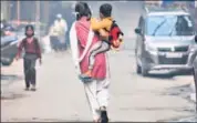  ??  ?? A girl holds a child as she returns from school in Noida.
HT FILE