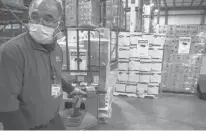  ?? MARK MIRKO/HARTFORD COURANT ?? Juan Donato loads medical supplies bound for Ukraine from a Hartford HealthCare warehouse in Newington.