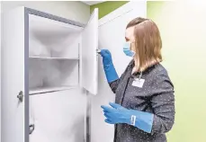  ?? CONTRIBUTE­D PHOTO ?? Lauren Grantz, LVHN director of pharmacy operations, shows a freezer where vials of Pfizer and BioNTech’s COVID-19 vaccine will be stored. The vaccine must be stored at temperatur­es of at least minus 94 degrees Fahrenheit.