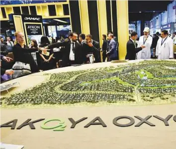  ?? Virendra Saklani/Gulf News ?? A model of Damac’s Akoya Oxygen project at Cityscape Global last year. Constructi­on continues at villas and apartments at Akoya Oxygen, and the golf course is also shaping up.
