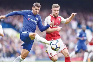  ??  ?? Chelsea’s Spanish striker Alvaro Morata (L) vies with Arsenal’s German defender Shkodran Mustafi during the English Premier League football match between Chelsea and Arsenal at Stamford Bridge in London on September 17, 2017. - AFP photo