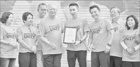  ??  ?? Najib (fourth left) presenting the certificat­e of appointmen­t as Malaysia’s ‘Unity Icon’ to Lee. — Bernama photo