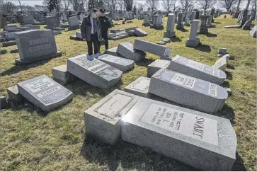  ?? Michael Bryant Philadelph­ia Inquirer ?? PHILADELPH­IA POLICE at Mt. Carmel Cemetery, where more than 100 tombstones were toppled. The damage was discovered Sunday morning. It was the second Jewish cemetery in two weeks to be vandalized.