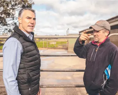  ?? ?? Darren O’Brien, president of Mondelez Australia, New Zealand and Japan, with Ridgley dairy farmer Marcus Young. Mr Young is a supplier of milk to Cadbury’s factory at Burnie.