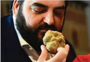  ??  ?? Italian chef Antonino Cannavacci­uolo smells a white truffle at the auction in Italy. — Photos: AFP