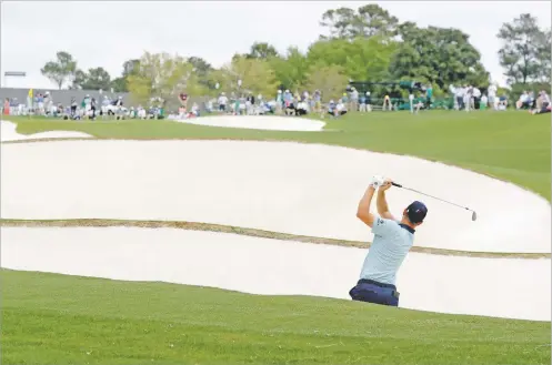  ?? CURTIS COMPTON/ATLANTA JOURNAL-CONSTITUTI­ON VIA AP ?? Justin Rose hits out of a fairway bunker on the 18th hole during the second round of the Masters on Friday in Augusta, Ga.