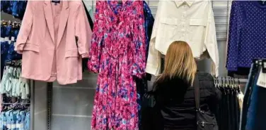  ?? Associated Press ?? A shopper looks at clothes at a Walmart store in Secaucus, New Jersey.