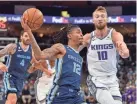  ?? BRANDON DILL/AP ?? Memphis guard Ja Morant drives to the basket as Sacramento forward Domantas Sabonis defends on Tuesday in Memphis.