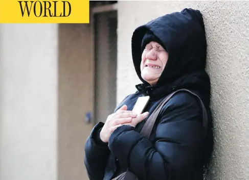  ?? JULIO CORTEZ / THE ASSOCIATED PRESS ?? Nilda Guerrero, a friend of the superinten­dent of an apartment building where 12 people died in a fire on Thursday, cries after trying to visit the Bronx building. New York City’s deadliest residentia­l fire in decades was accidental­ly lit by a boy,...