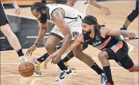  ?? Darren Abate / Associated Press ?? The Nets’ James Harden, left, and Spurs’ Patty Mills battle for the ball. The game wasn’t over for this edition. See timesunion.com for a story