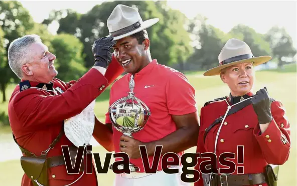  ?? — AP ?? Special treatment: Jhonattan Vegas holding the winner’s trophy as he tries on a Mountie stetson following his win at the Canadian Open in Oakville, Ontario, on Sunday.