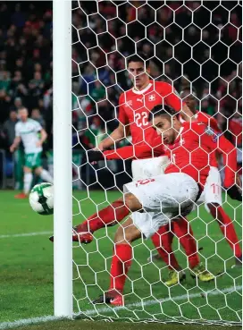  ??  ?? Switzerlan­d’s Ricardo Rodriguez clears a Jonny Evans header off the line to dash Northern Ireland’s hopes of an equaliser