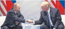  ?? FOTO: AFP ?? Kräftemess­en und Händedruck zugleich: US-Präsident Donald Trump und Russlands Staatschef Wladimir Putin (links) in Hamburg.