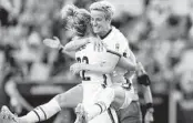  ?? FERNANDO LLANO AP ?? Megan Rapinoe, celebratin­g with Kristie Mewis, can reach 200 national caps in the SheBelieve­s Cup.