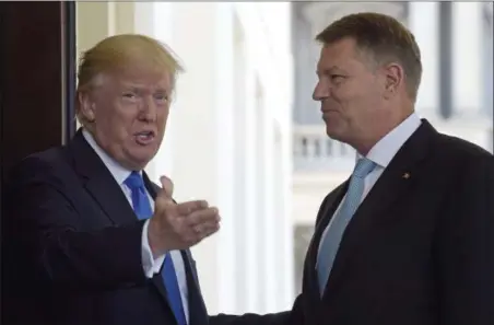  ?? SUSAN WALSH — THE ASSOCIATED PRESS ?? President Donald Trump welcomes Romania’s President Klaus Werner Iohannis to the White House in Washington, Friday.