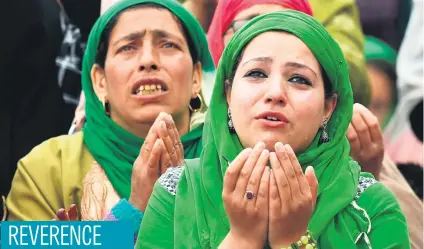  ?? Picture: AFP ?? Kashmiri Muslims pray as a custodian displays a holy relic, believed to be a hair from the Prophet Muhammad’s beard, during celebratio­ns for Miraj-Ul-Alam at Kashmir’s Hazratbal Shrine in Srinagar yesterday.