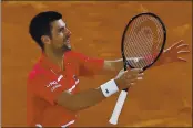  ?? ALESSANDRA TARANTINO — THE ASSOCIATED PRESS ?? Novak Djokovic celebrates winning his semifinal match of the French Open tournament against Greece’s Stefanos Tsitsipas in five sets at the Roland Garros stadium in Paris.