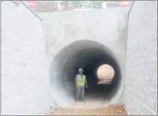  ?? Keith Bryant/The Weekly Vista ?? Alex Guzman, with Crossland Constructi­on, stands in a 10-foot-tall tunnel under Forest Hills Blvd. Guzman said he’s worked on most of the trail tunnels around Bella Vista and he’s finishing earthwork around this particular tunnel, which is expected to be complete sometime this week.