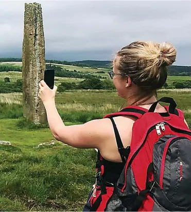  ??  ?? Click and conserve: PhD researcher Rosie Brigham at the Machrie Stones on Arran