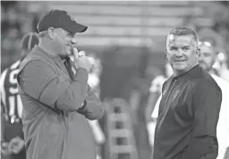  ?? CHERYL EVANS/AZCENTRAL SPORTS ?? Arizona coach Rich Rodriguez, left, and Arizona State coach Todd Graham talk before the 90th Territoria­l Cup at Arizona Stadium in Tucson last Nov. 25.