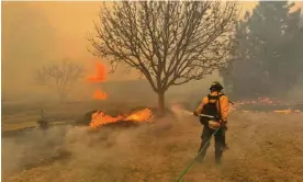  ?? ?? A firefighte­r battling the Smokehouse Creek Fire, near Amarillo, in the Texas Panhandle, on Wednesday. Photograph: Flower Mound Fire Department/AFP/Getty Images