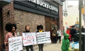  ?? RON TODT — THE ASSOCIATED PRESS ?? Protesters gather outside a Starbucks in Philadelph­ia, Sunday where two black men were arrested Thursday after Starbucks employees called police to say the men were trespassin­g. The arrest prompted accusation­s of racism on social media. Starbucks CEO...