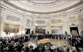  ?? AP/CHIP SOMODEVILL­A ?? The body of evangelist Billy Graham lies in honor Wednesday in the rotunda of the U.S. Capitol. President Donald Trump and the Republican leaders of Congress held a prayer and placed wreaths at the casket. Arkansas’ congressio­nal delegation attended...