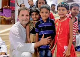  ?? — PTI ?? Congress president Rahul Gandhi poses with children during his visit to Basel Mission Church in Hubli, Karnataka, on Monday.