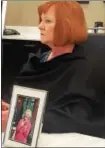  ??  ?? Mary Dimaio sits in front of a photo of her mother, Theresa Malloy, who perished in the Nov. 16 Barclay Friends Home fire, Wednesday, at her lawyer’s office in Center City Philadelph­ia.