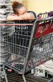  ?? AP ?? June Crouch waits at a supermarke­t in the hope of buying groceries