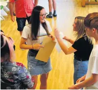  ??  ?? Olivia O’Neill (A* A* A*), centre, and Katie Moss (A* A C) at St Christophe­r’s High