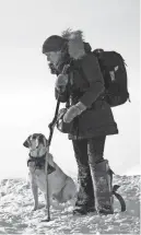  ?? KIMBERLY FRENCH ?? In “The Mountain Between Us,” Alex (Kate Winslet) and the pilot's dog emerge after a plane crash.