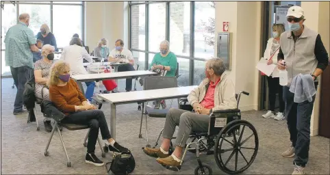  ?? (NWA Democrat-Gazette/Keith Bryant) ?? Volunteers stay busy as patients fill out a room at Mercy Bella Vista for Cornerston­e Pharmacy’s vaccine clinic April 8 in Bella Vista.