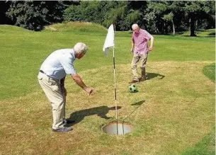  ??  ?? Ray Bullock and Bill Thompson enjoy a game of foot golf at Bruntwood Park pitch and putt