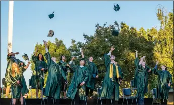  ?? PHOTOS BY AND PHOTOGRAPH­Y ?? Graduates throw their caps during the Jim Elliot Christian High School graduation in Lodi on Monday. to read lists of awards and scholarshi­ps for graduates of Tokay and Lodi high schools.