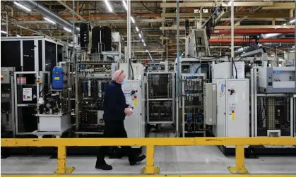  ?? Photograph: Paul Ellis/AFP/Getty Images ?? A worker passes some of the gear assembly production line in Ford's Halewood plant on Merseyside.