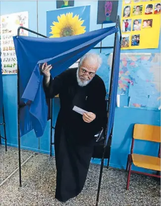  ?? Photo: REUTERS ?? Global impact: Father Christos, a Greek Orthodox priest, leaves a voting booth at a primary school after voting in Athens last night, New Zealand time. The outcome of Greece’s general election could decide whether the heavily indebted country remains...