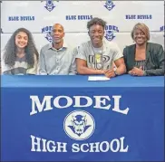  ?? Courtesy of Floyd County Schools ?? Model’s Jahari Merritt signs to continue his academic and football career at Dordt University in Sioux Center, Iowa. Merritt family pictured from left to right: Jordyn (sister), Robert (father), Jahari and Janice (mother).
