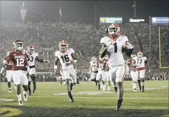  ?? JAE C. HONG – THE ASSOCIATED PRESS ?? Georgia running back Sony Michel (1) scores the winning touchdown in the second overtime of a College Football Playoff semifinal game on Monday at the Rose Bowl game in Pasadena, Calif.